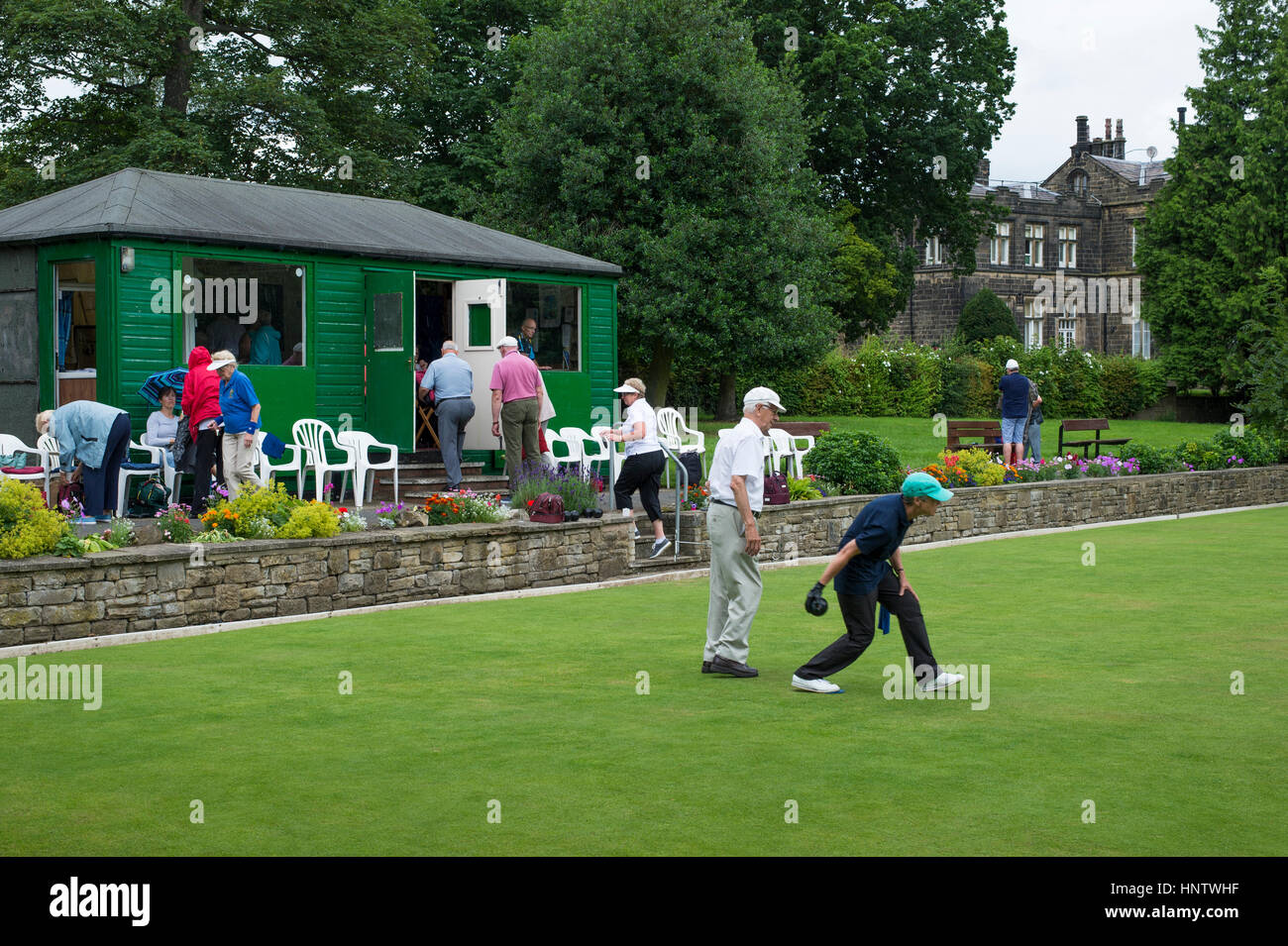 Competitors and spectators at a crown green bowling match on the bowling green in the village of Burley In Wharfedale, West Yorkshire, England. Stock Photo