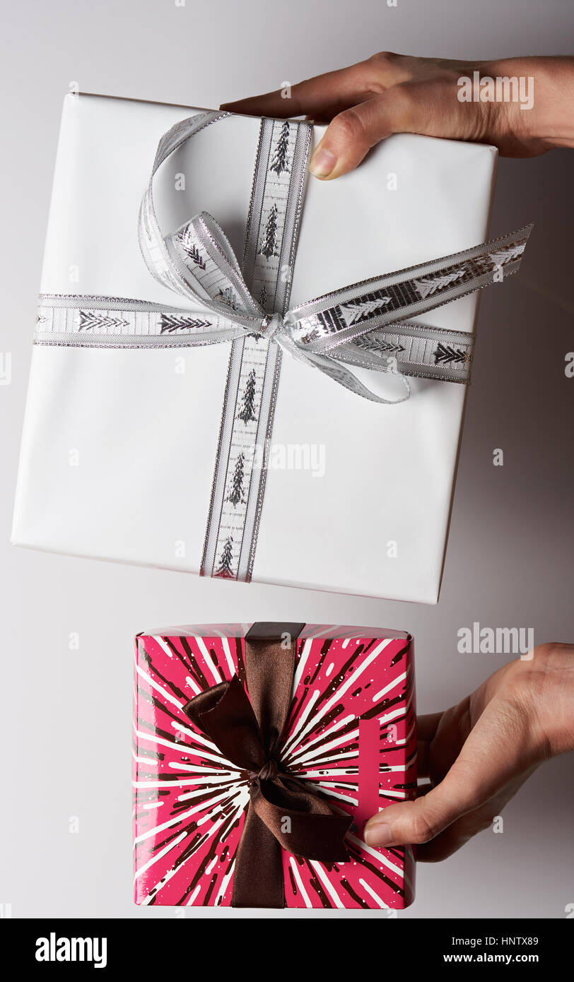 Two gift boxes in hands view above isolated on white background Stock Photo