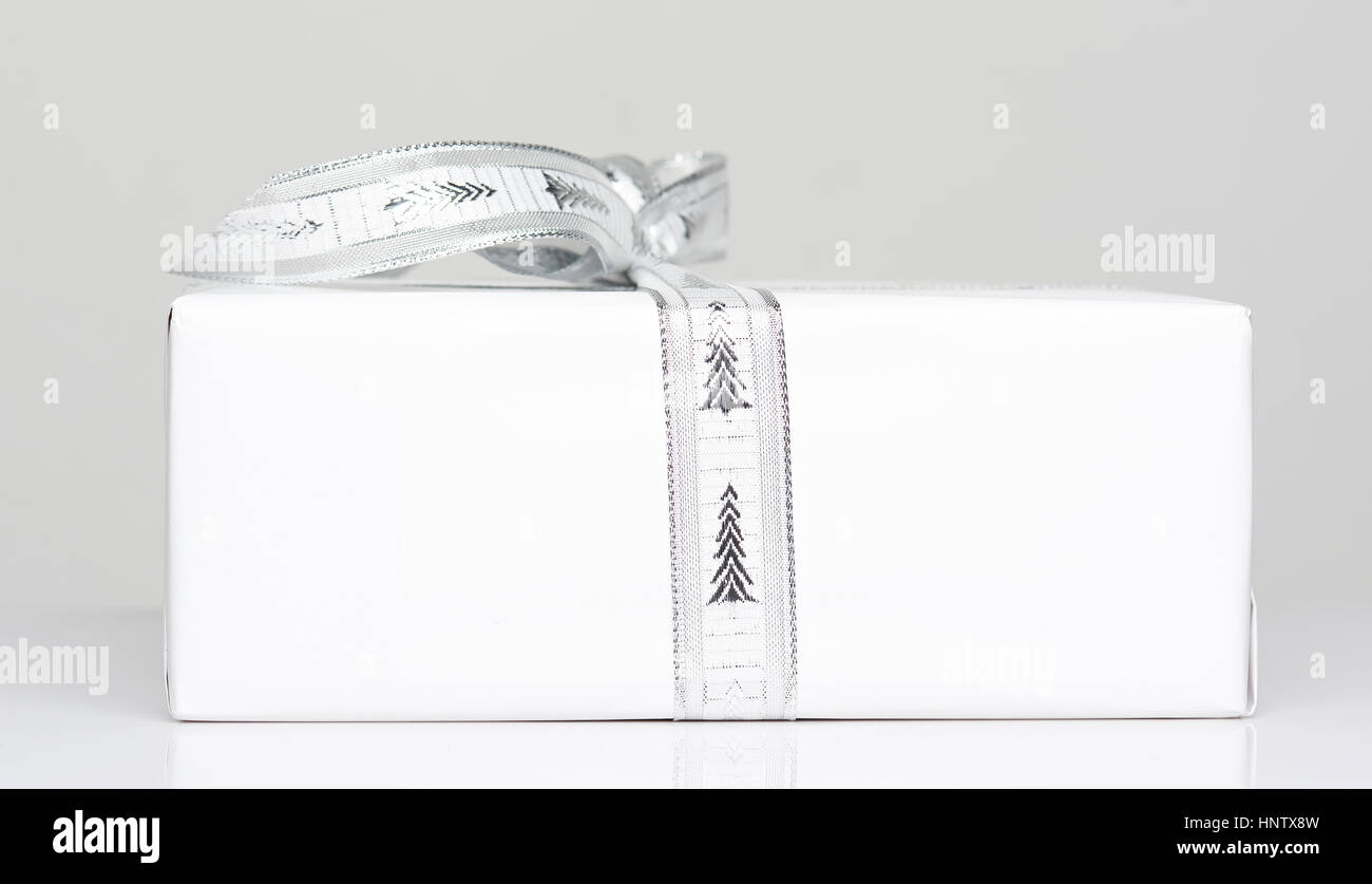 Side of white gift box with ribbon bow close up Stock Photo