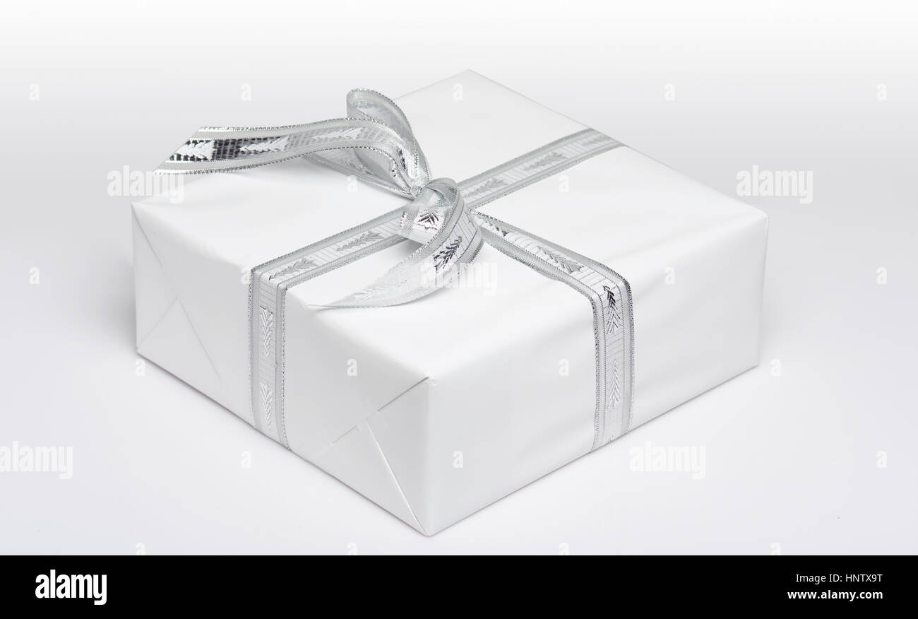 One white gift box with white ribbon view from angle isolated Stock Photo