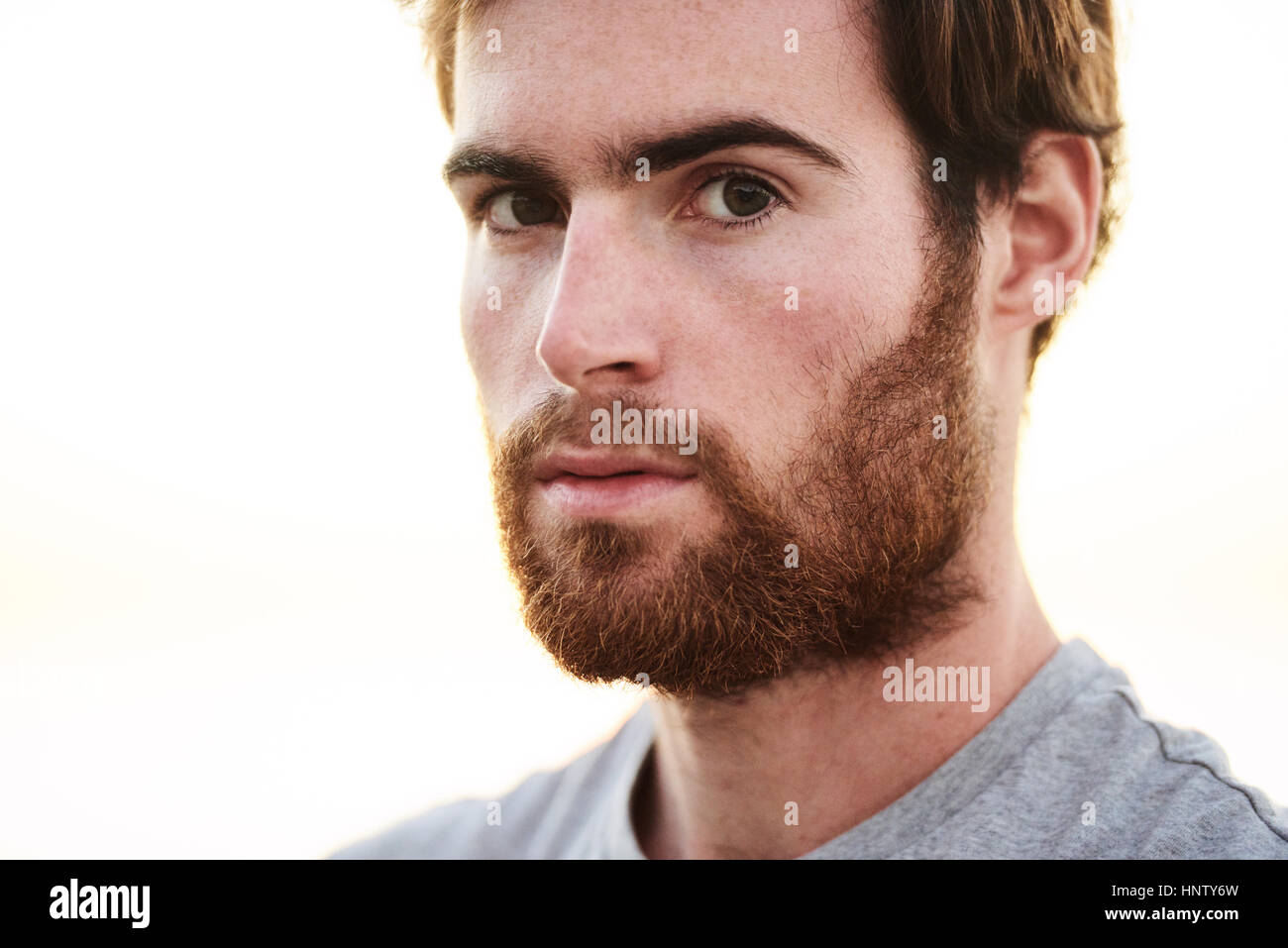 white bearded male looking into camera with serious facial expression Stock Photo