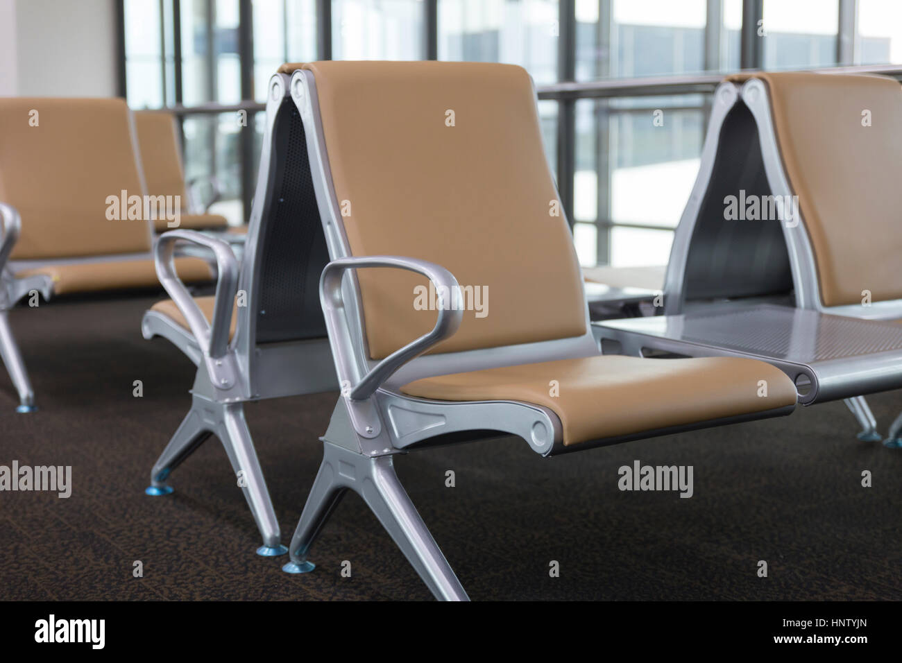 brown leather chair in airport terminal building Stock Photo - Alamy