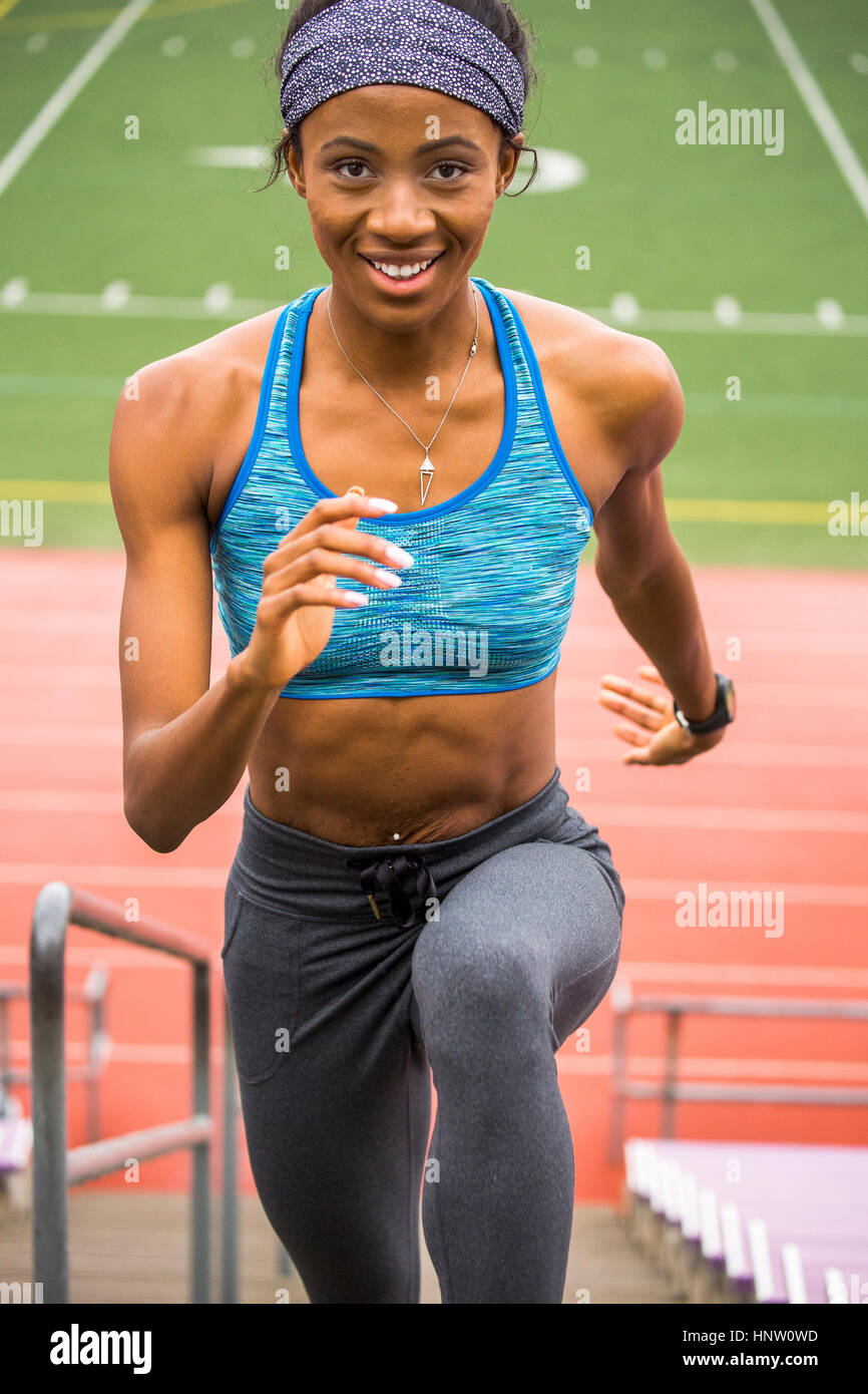 Premium Photo  A woman in a sports bra top running on a track
