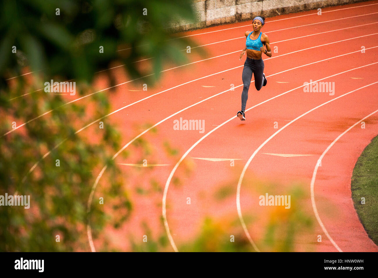 Black woman running on track Stock Photo