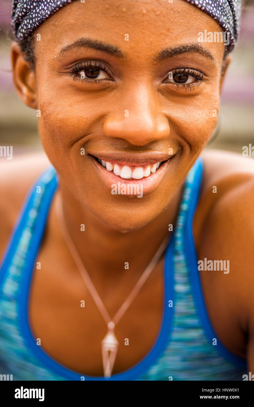 Smiling Black woman sweating Stock Photo