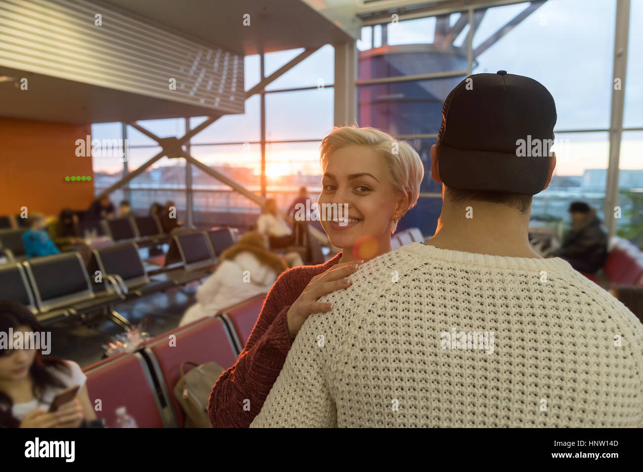 Young Couple In Airport Lounge Waiting Departure Happy Smile Man And Woman Stock Photo