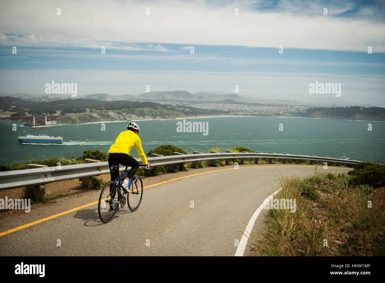 Hispanic Man Riding Bike Hispanic man riding bicycle on waterfront road Stock Photo - Alamy