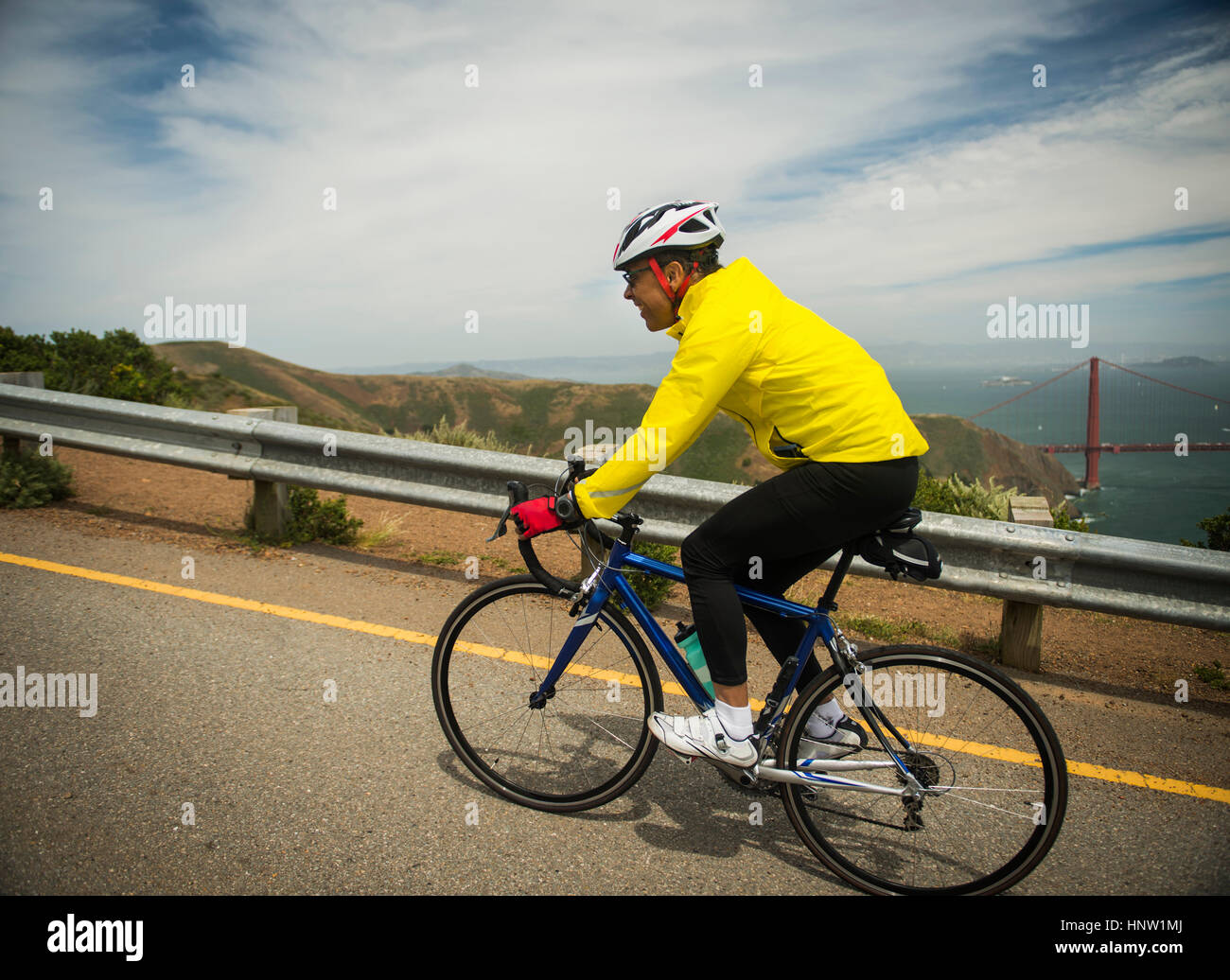 Hispanic Man Riding Bike Hispanic man riding bicycle on waterfront road Stock Photo - Alamy