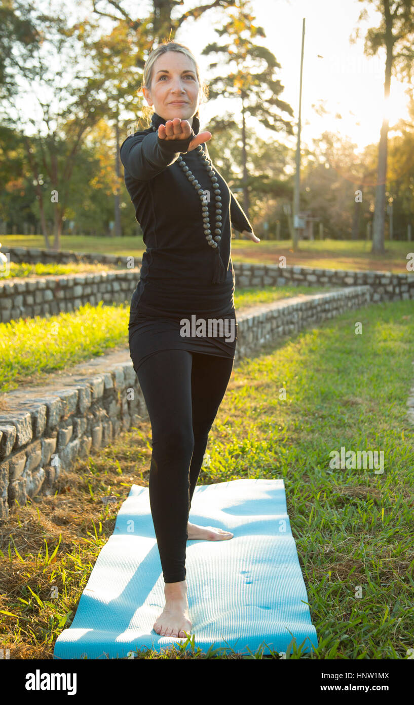 Caucasian woman practicing yoga in park Stock Photo