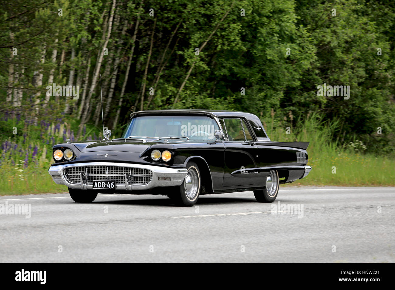 KARJAA, FINLAND - JUNE 5, 2016: Classic black Ford Thunderbird car, probably year 1960, moves along highway in the summer. Stock Photo