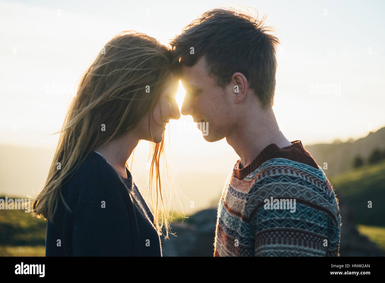 Caucasian couple face to face in landscape Stock Photo
