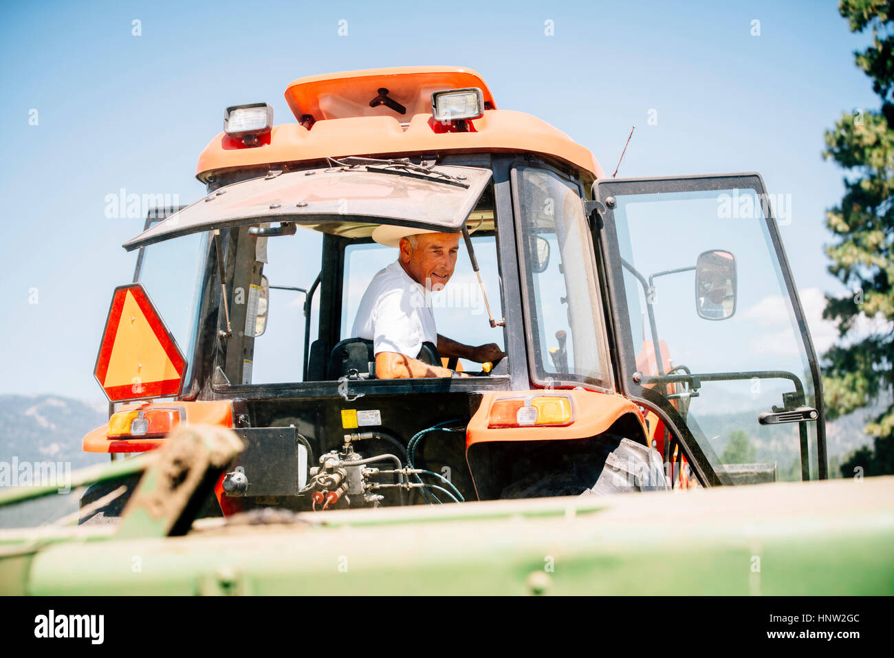 Farmer driving tractor hires stock photography and images Alamy