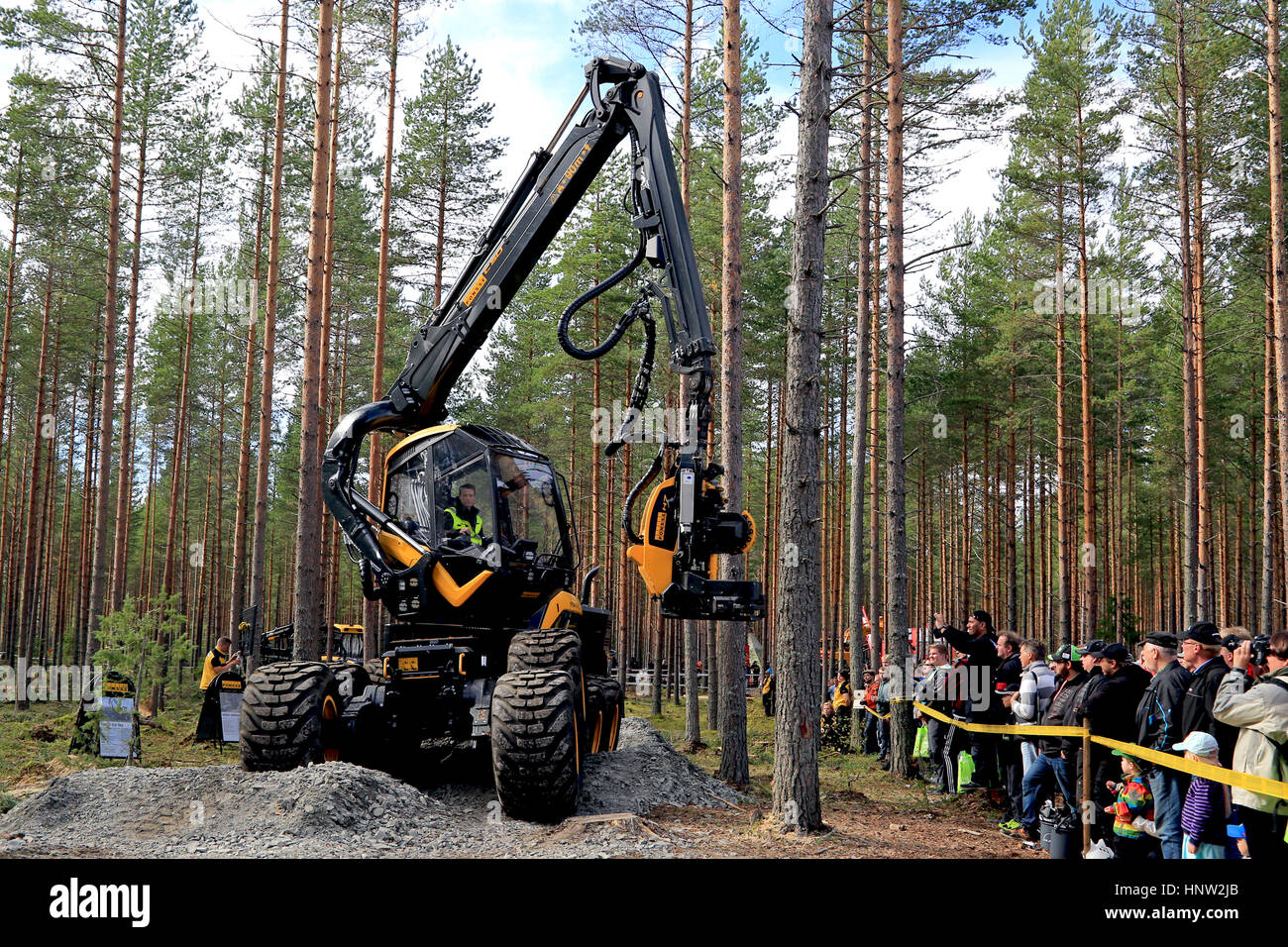 JAMSA, FINLAND - SEPTEMBER 2, 2016: Ponsse forest harvester operator shows the Scorpion King harvester head H7 to interested viewers in a work demonst Stock Photo