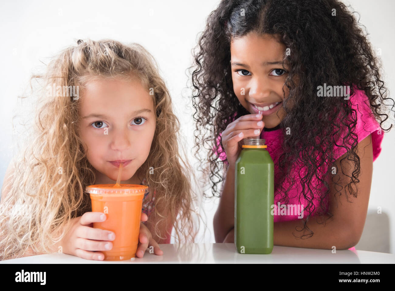 Girls drinking healthy smoothies Stock Photo