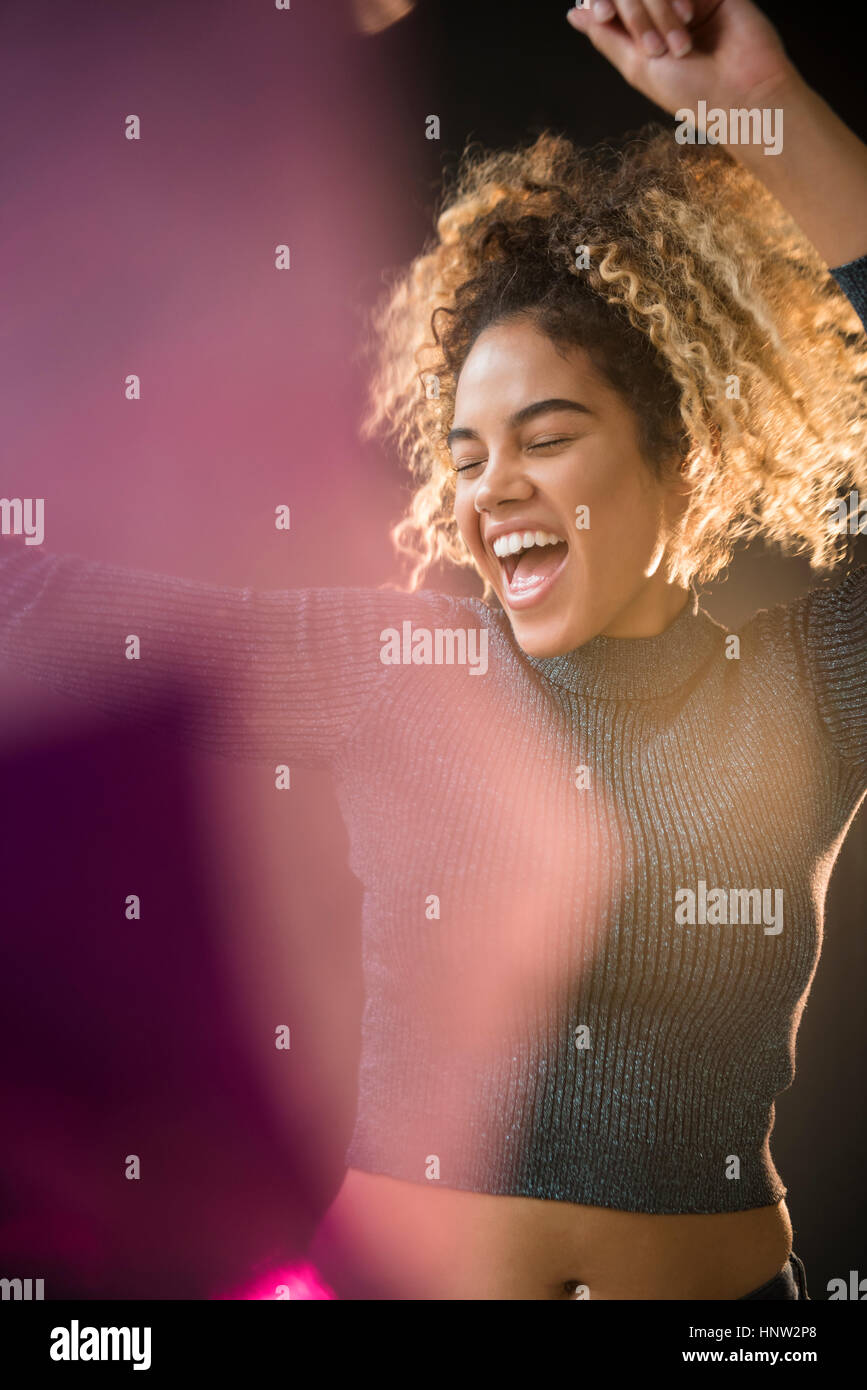 Mixed Race woman wearing sweater dancing Stock Photo Alamy