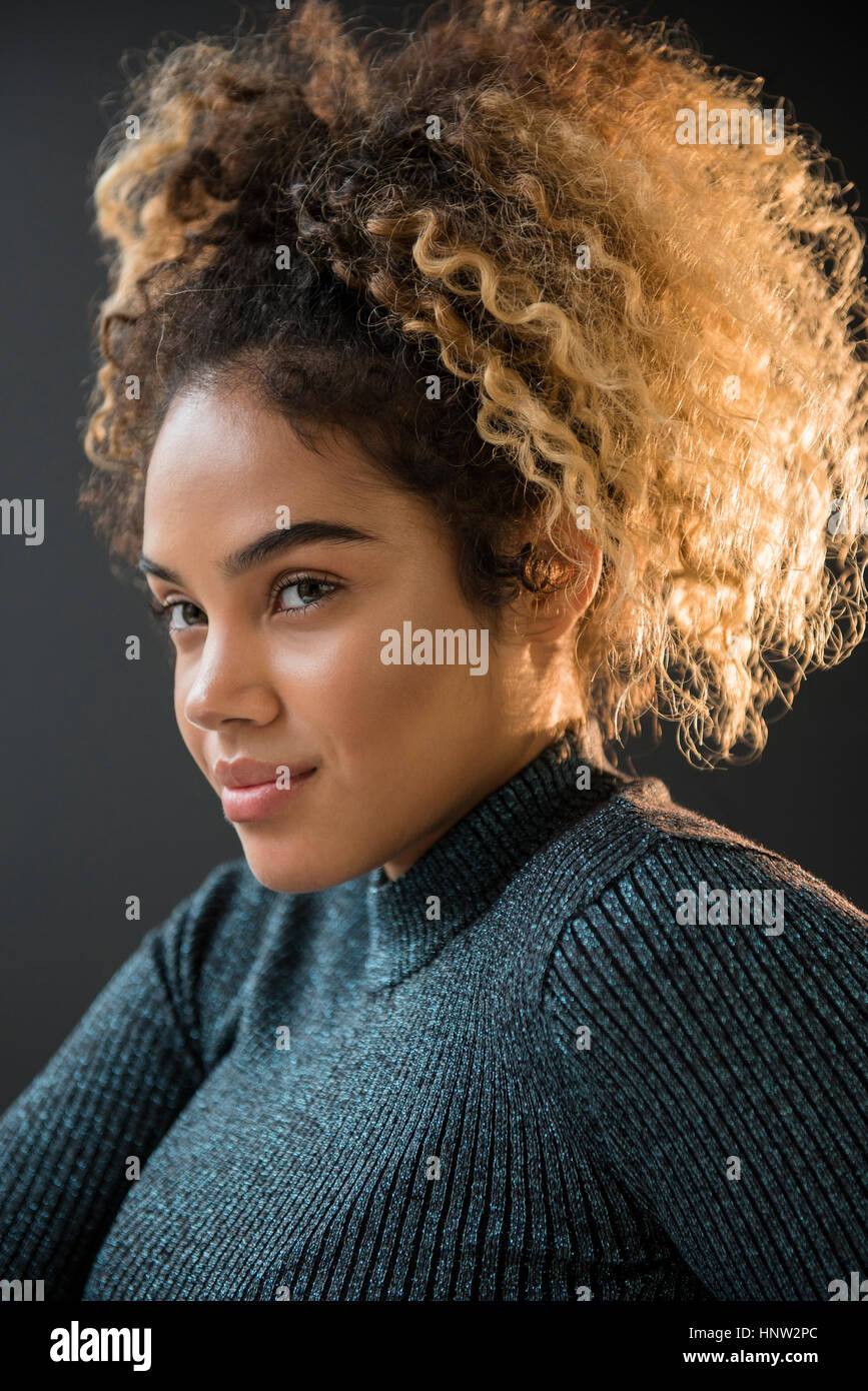 Portrait of Mixed Race woman wearing sweater Stock Photo