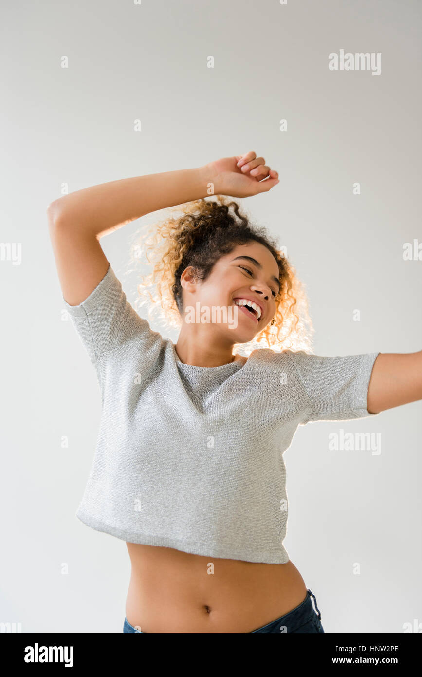 Mixed Race woman dancing Stock Photo