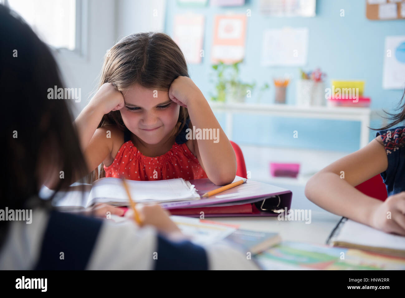 Frustrated girl staring at notebook in school Stock Photo