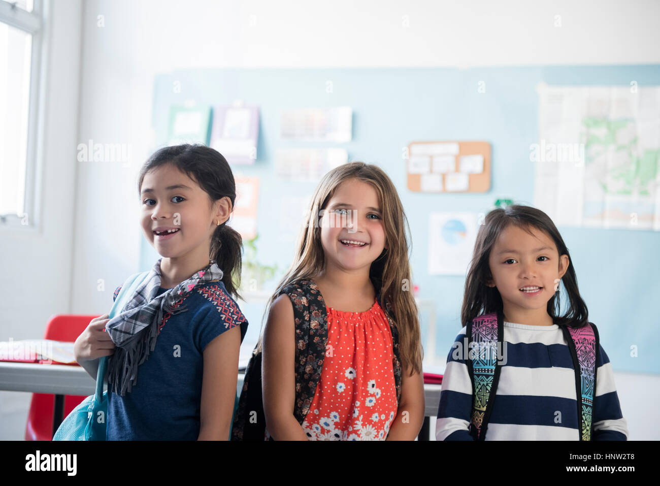 Portrait of girls smiling in classroom Stock Photo