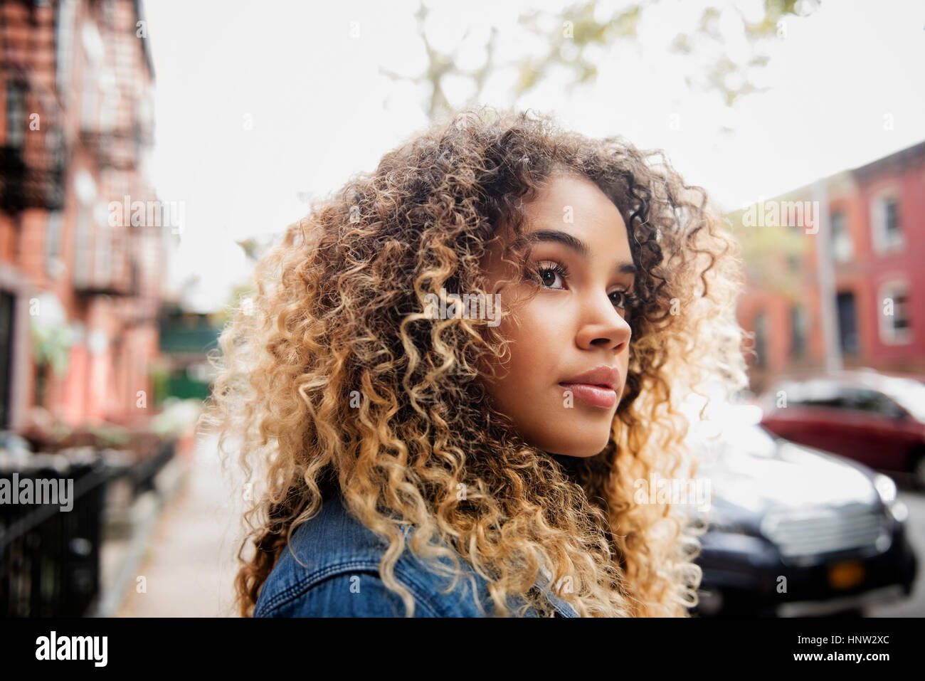 Pensive Mixed Race woman in city Stock Photo