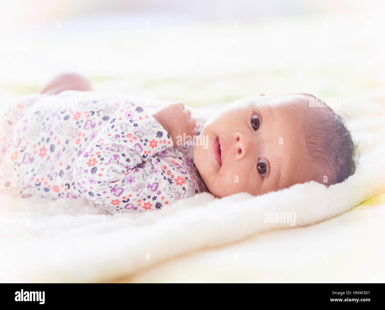Portrait of Hispanic baby girl laying on blanket Stock Photo Alamy
