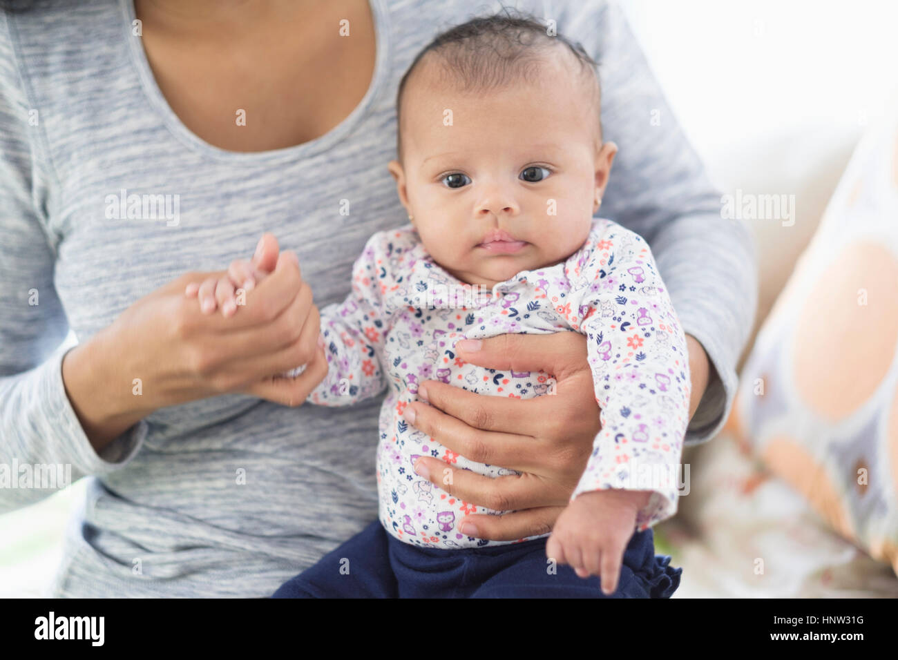 Hispanic mother holding baby daughter Stock Photo