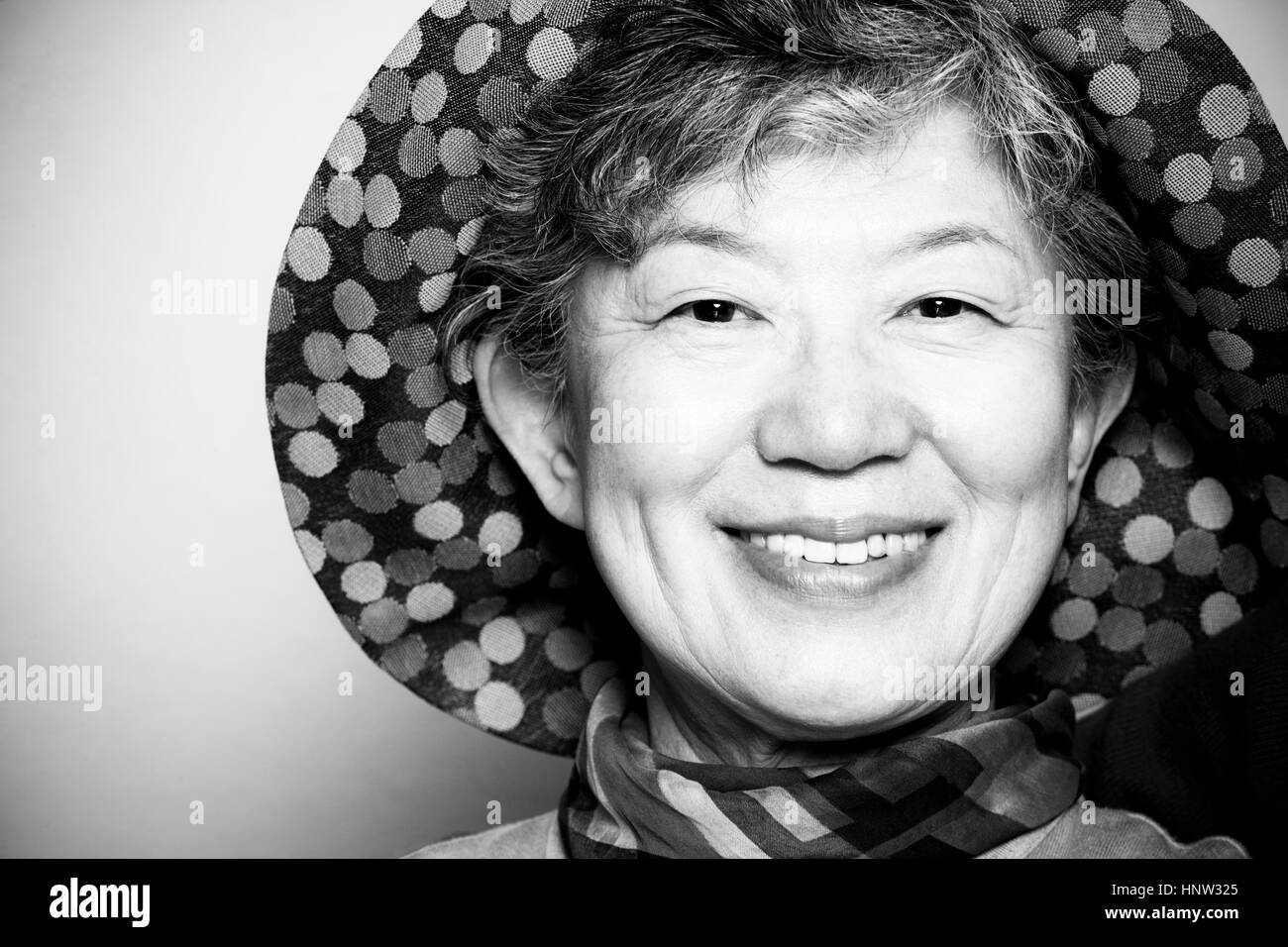 Portrait of smiling Japanese woman wearing hat Stock Photo