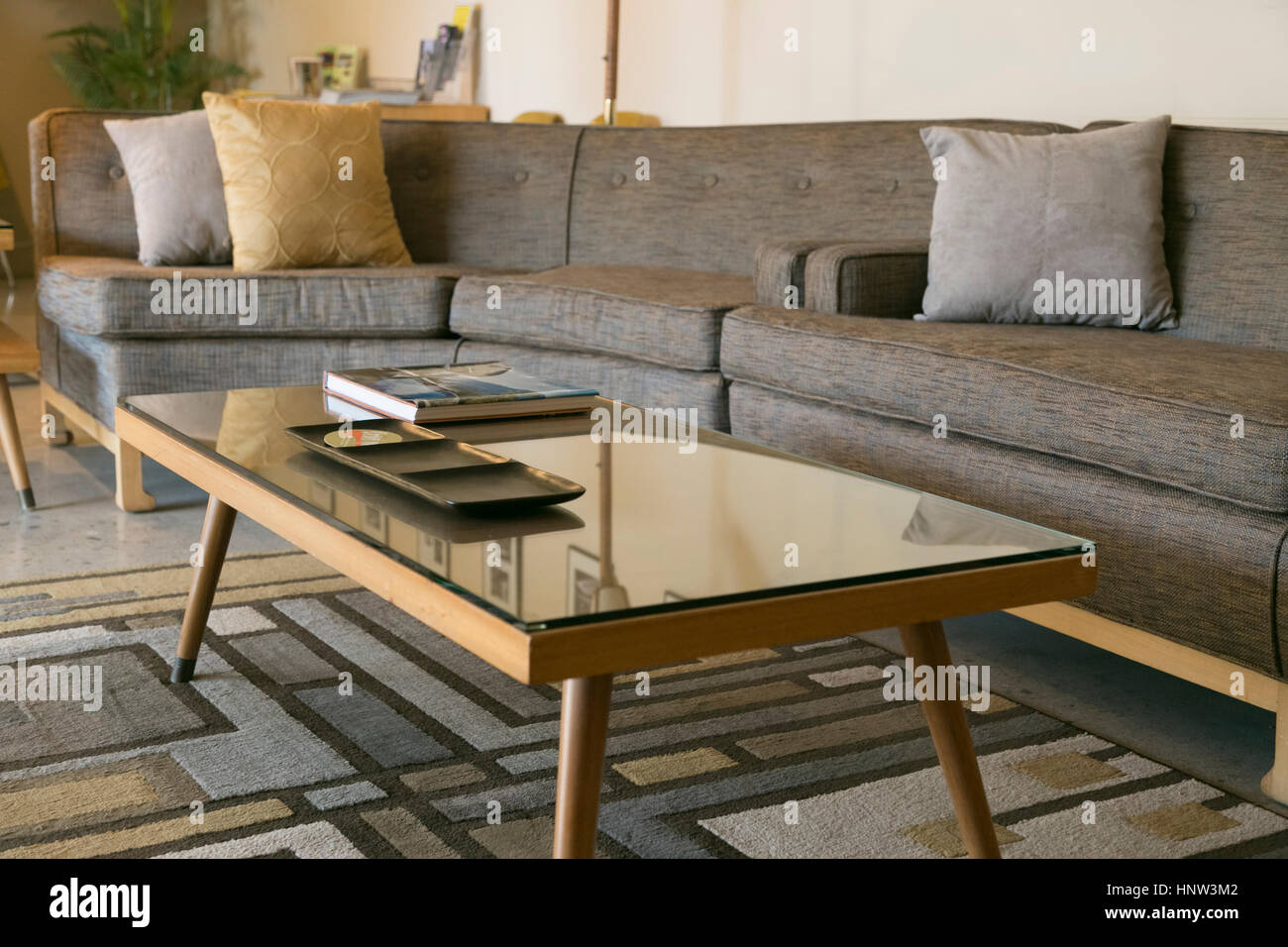 Coffee table with glass and sectional sofa Stock Photo