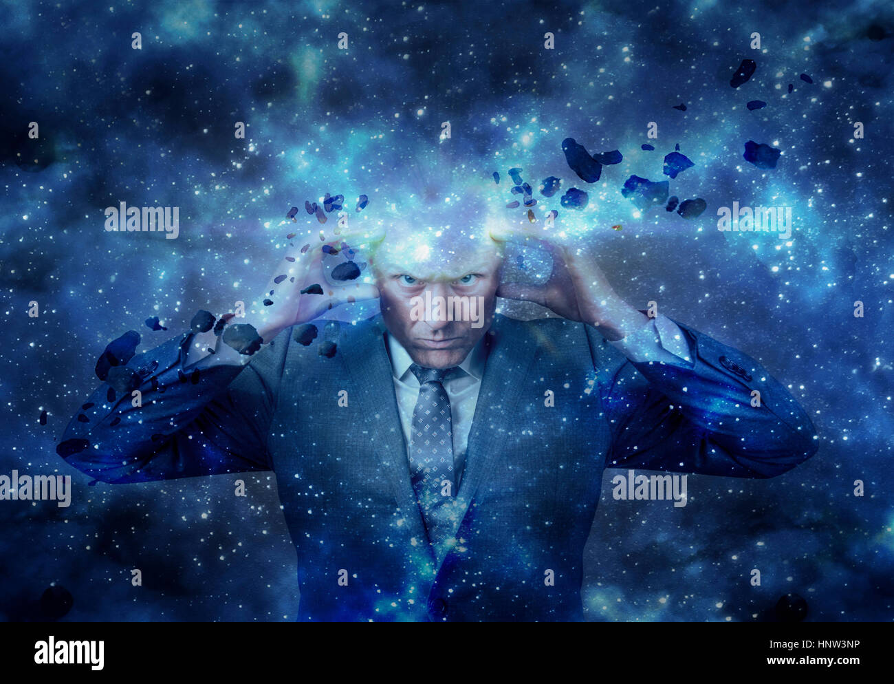Head of businessman exploding in outer space Stock Photo