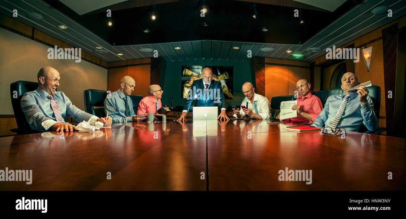 Multiple exposure of Caucasian businessmen in conference room Stock Photo