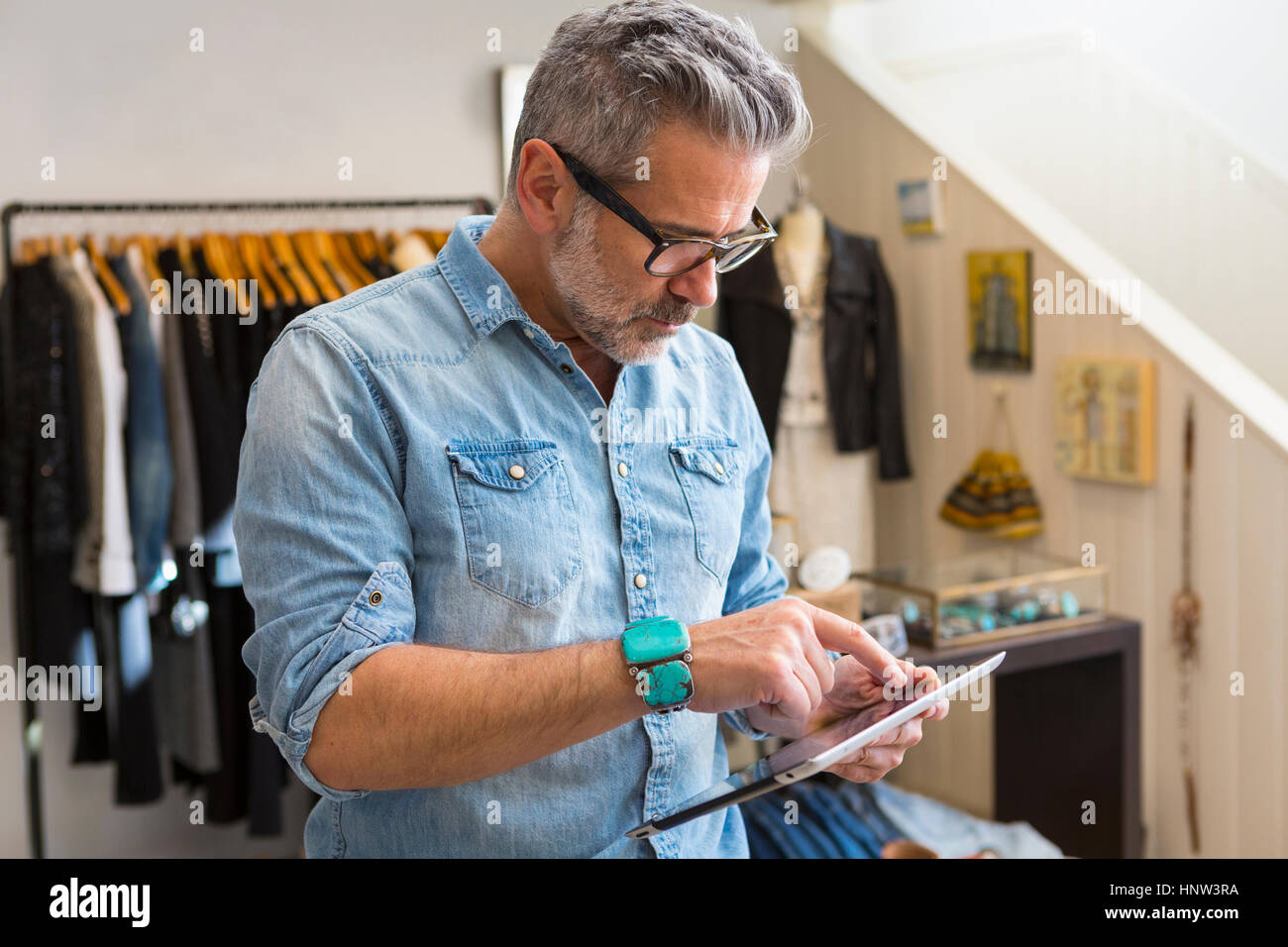 Caucasian man using digital tablet in store Stock Photo