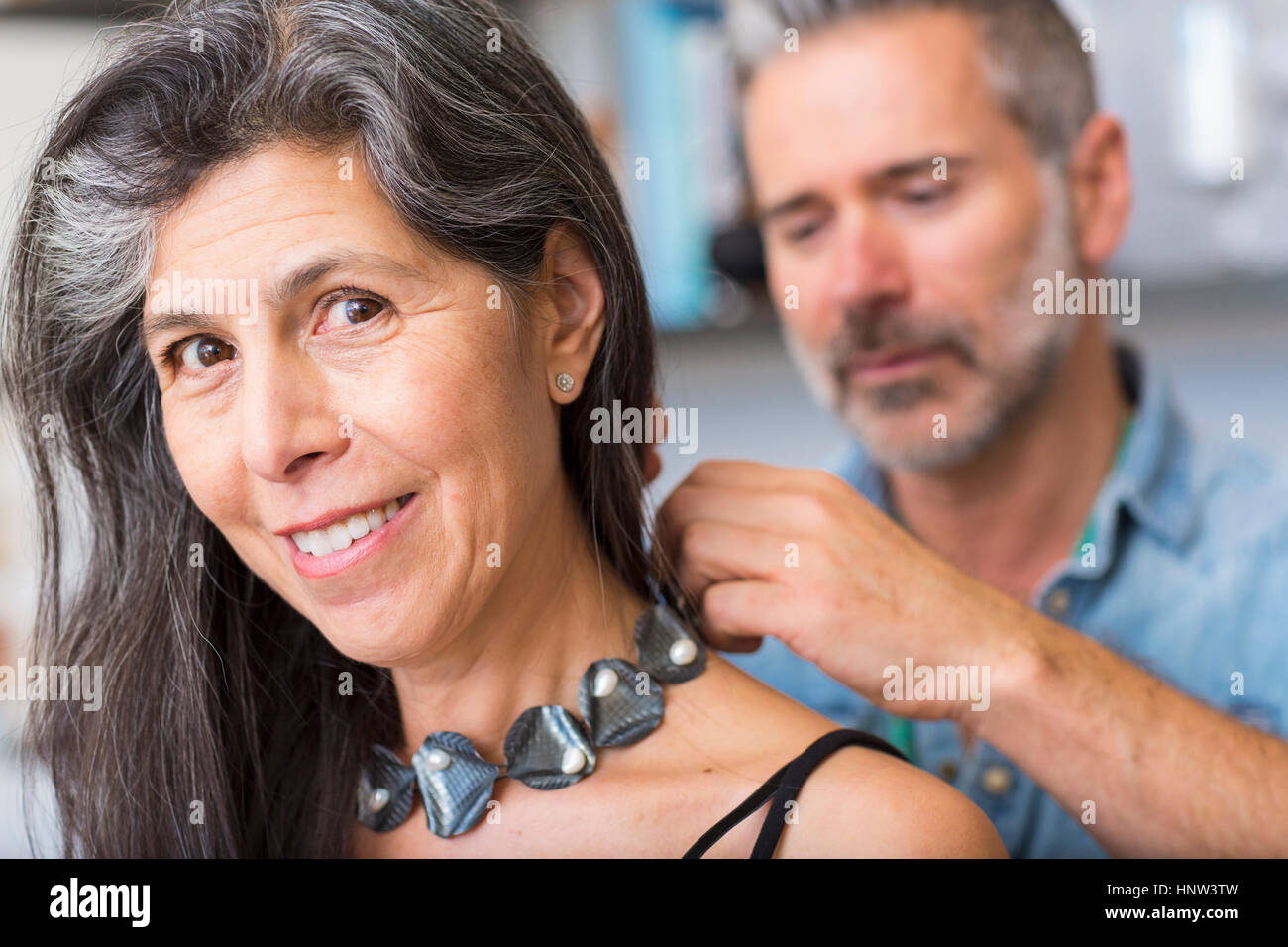 Man fastening necklace for woman Stock Photo