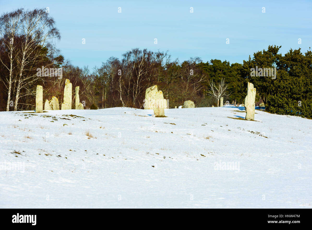 Ancient burial ground with standing stones and lots of mounds in winter landscape. Location Hjortahammar in Blekinge, Sweden. Stock Photo