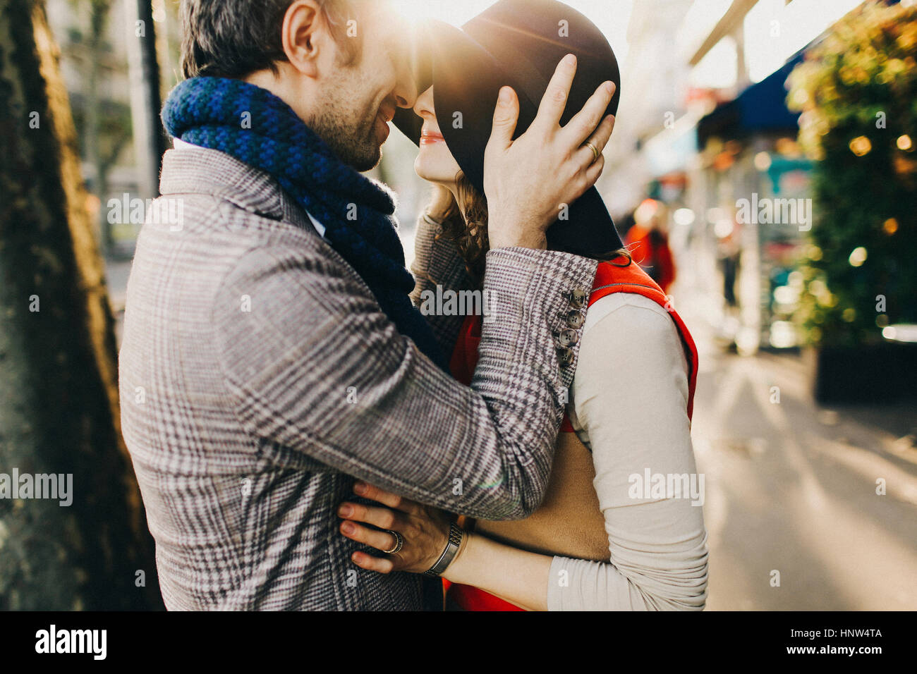 Caucasian couple rubbing noses on sunny day Stock Photo