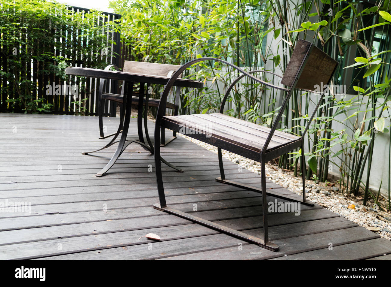 wooden desk and chair on patio beside garden Stock Photo - Alamy