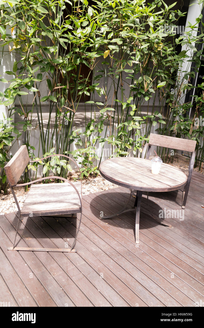 wooden desk and chair on patio beside garden Stock Photo - Alamy