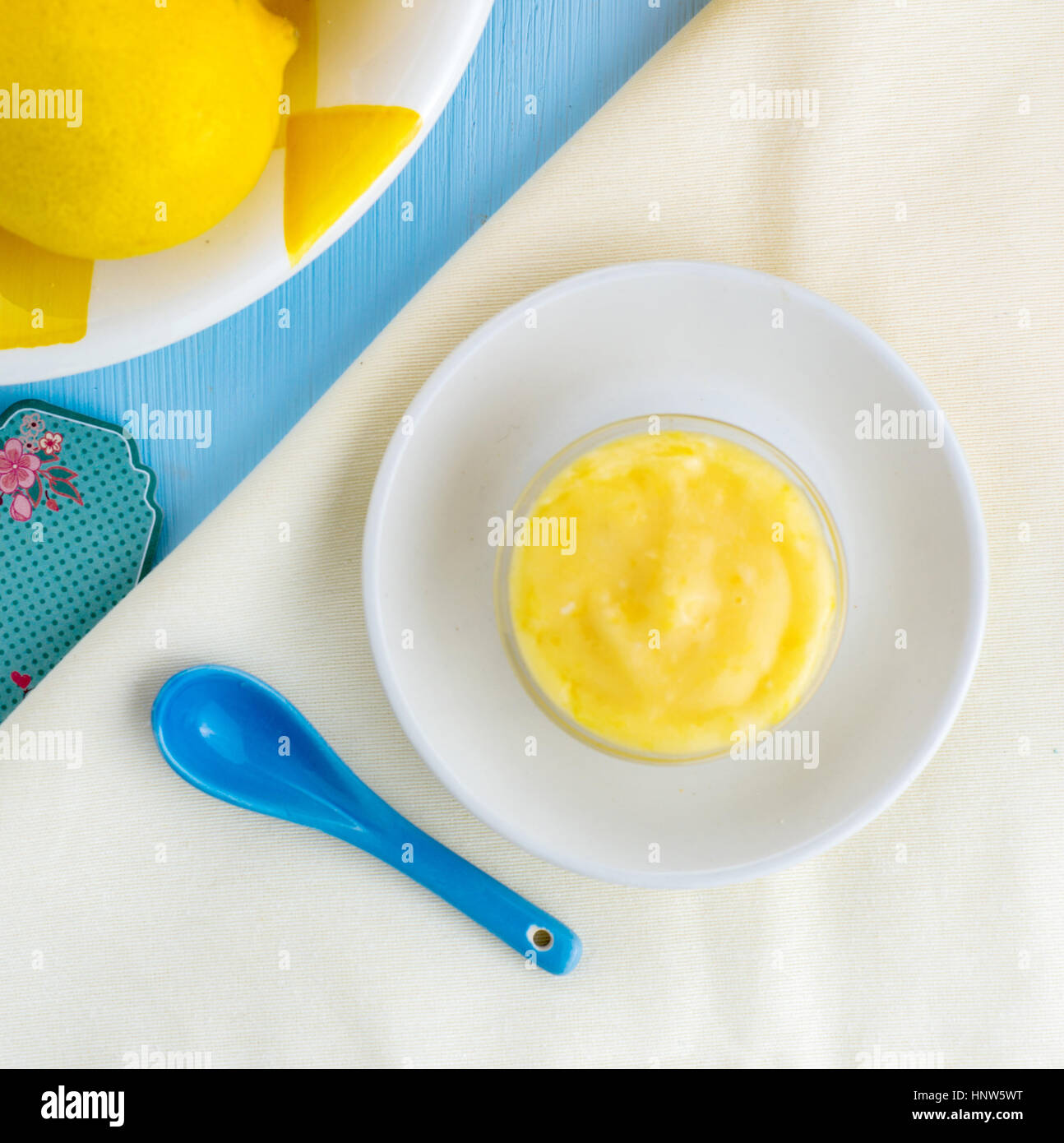 Square image of homemade lemon curd with lemons, blue and yellow colors with copy space Stock Photo