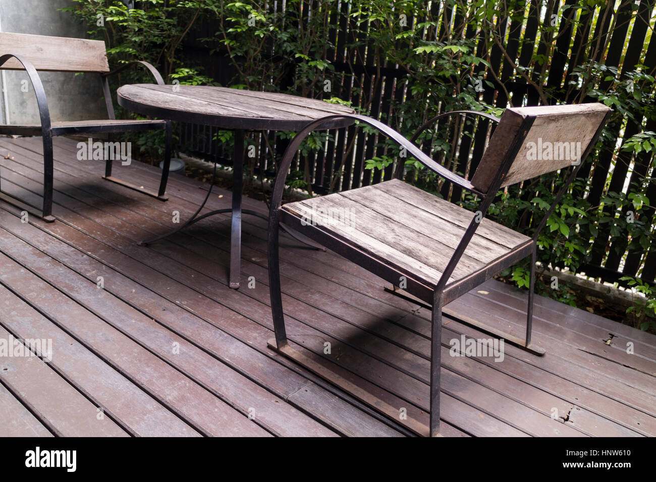 wooden desk and chair on patio beside garden Stock Photo - Alamy