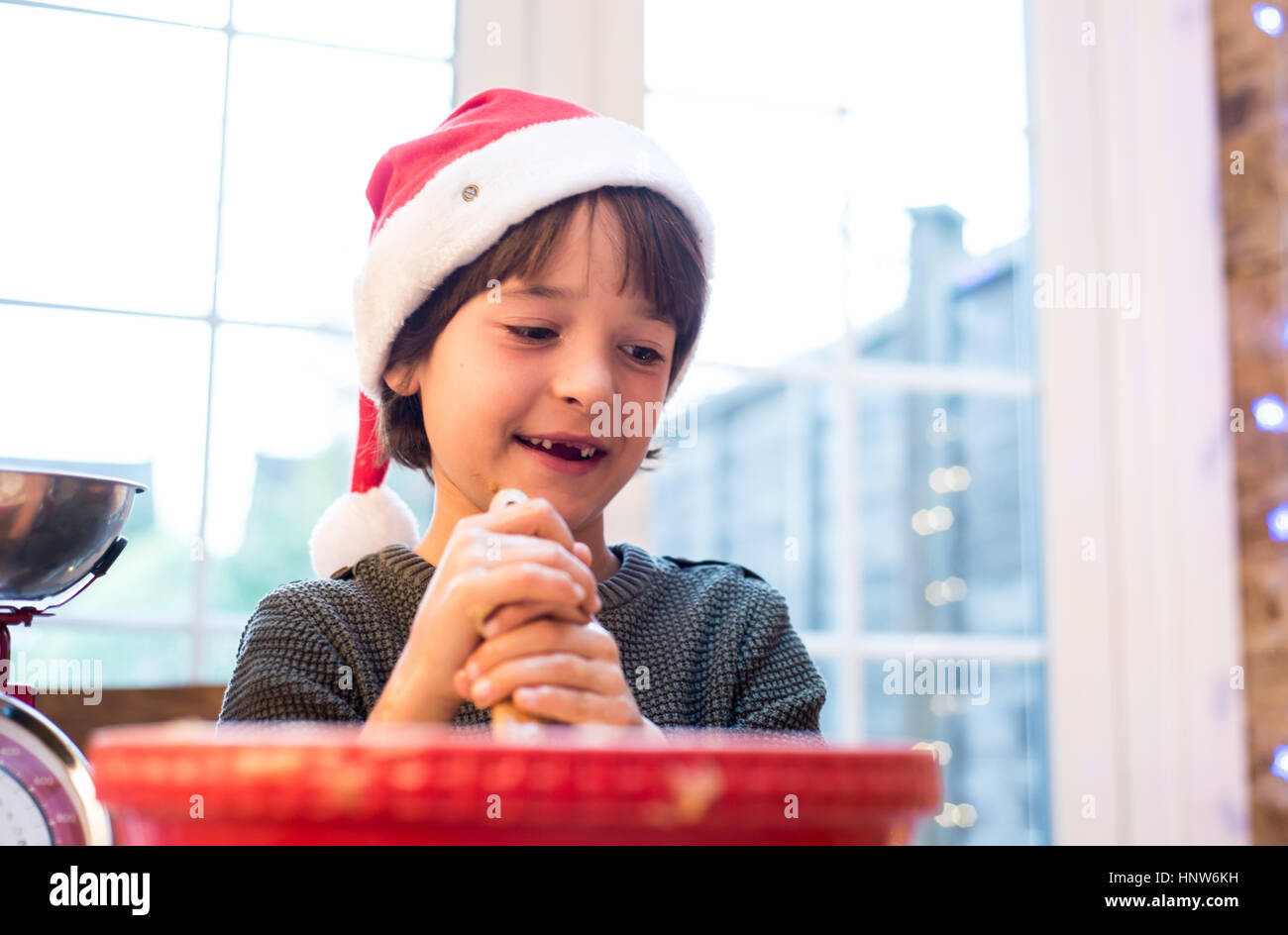 Portrait of boy holding rolling pin, smiling Stock Photo