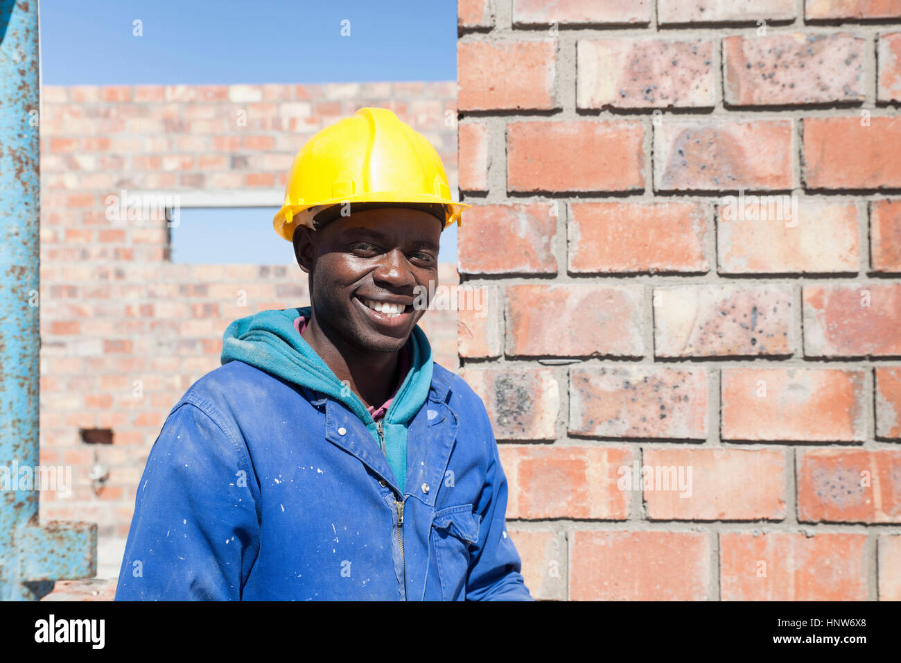 Portrait of builder wearing hard hat looking at camera smiling Stock Photo