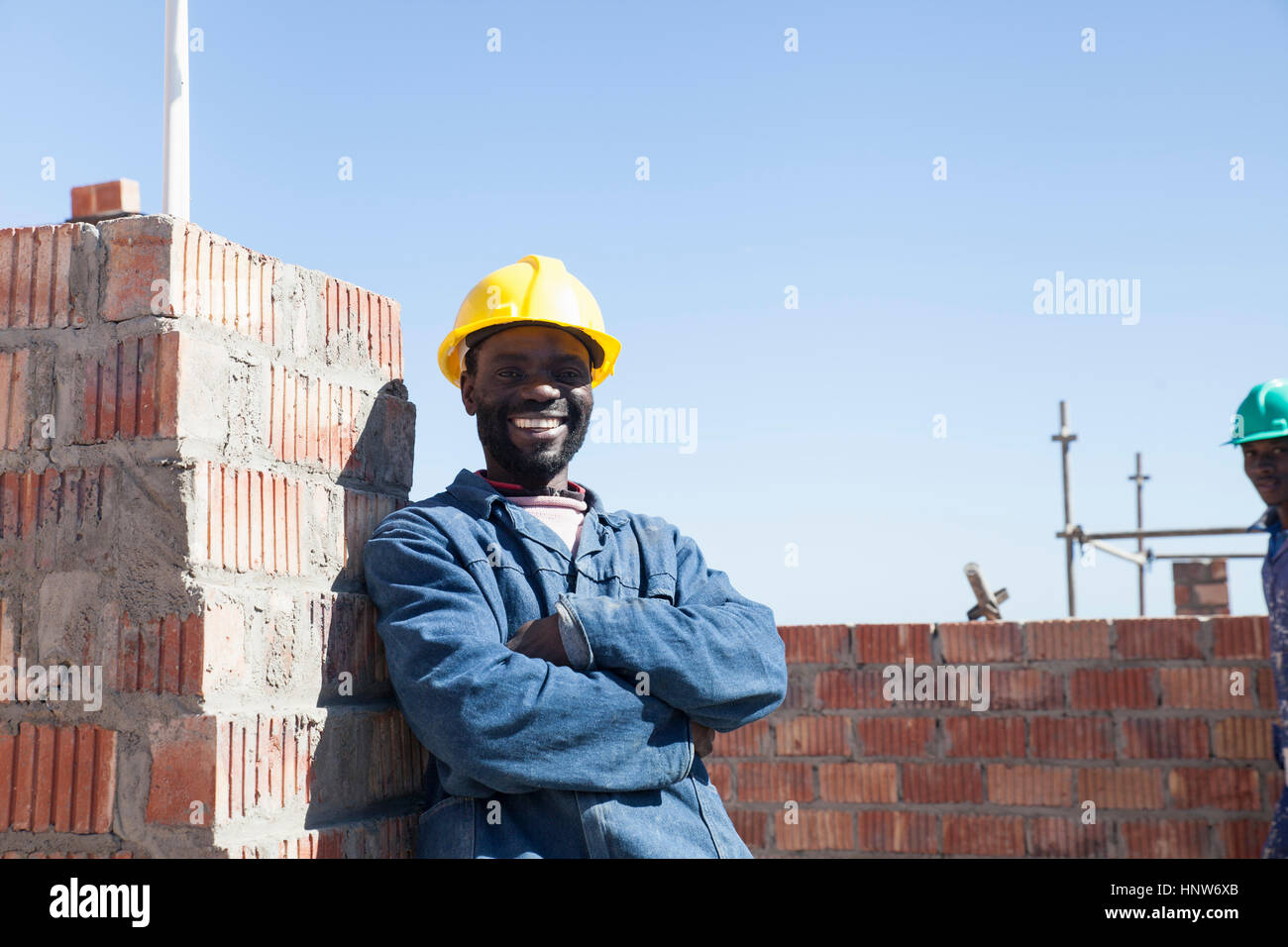 Portrait of builder wearing hard hat looking at camera smiling Stock Photo