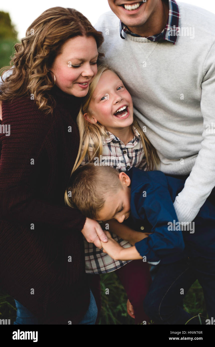 Family hugging and smiling Stock Photo