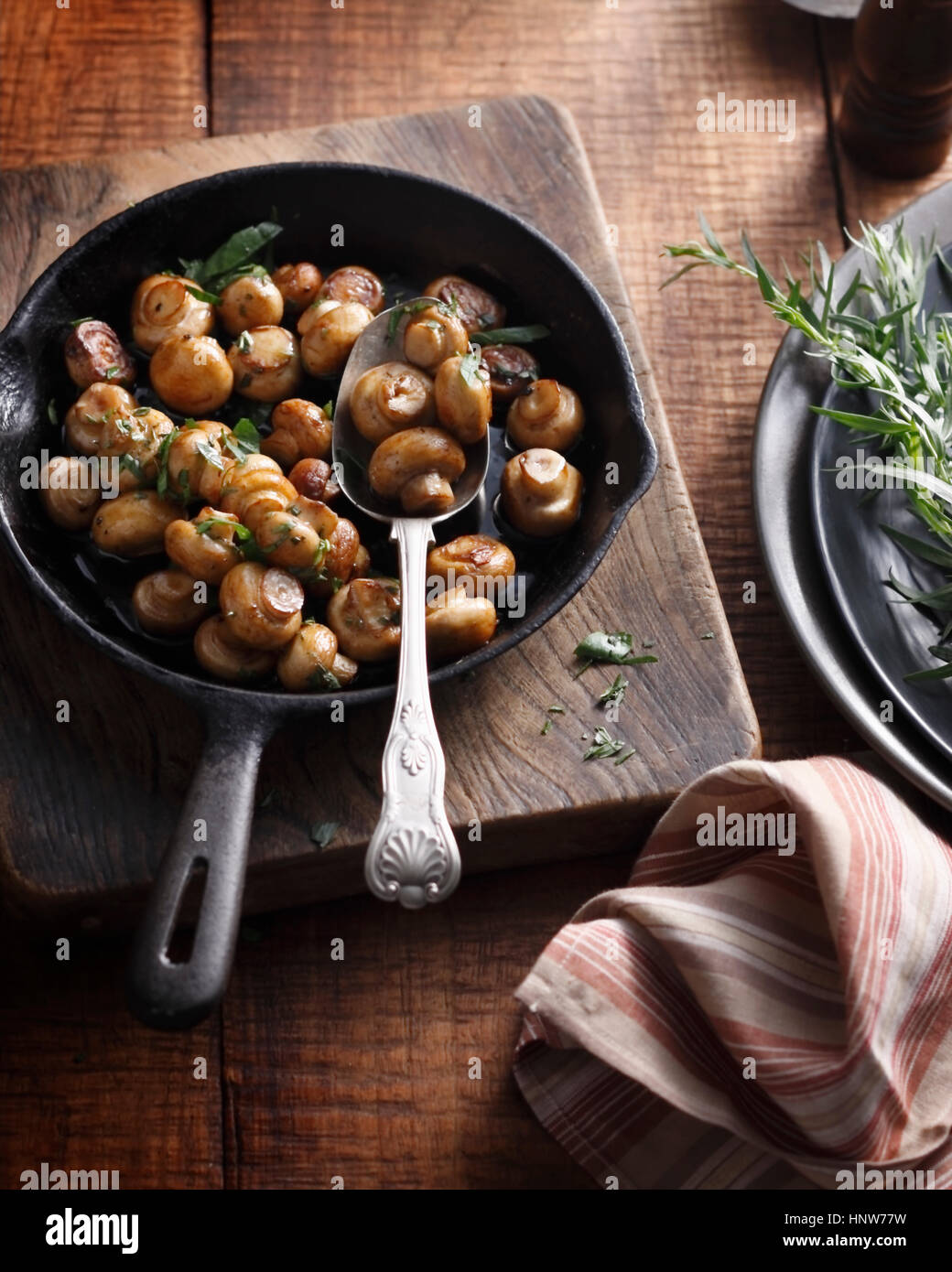 Tarragon button mushrooms in frying pan Stock Photo Alamy