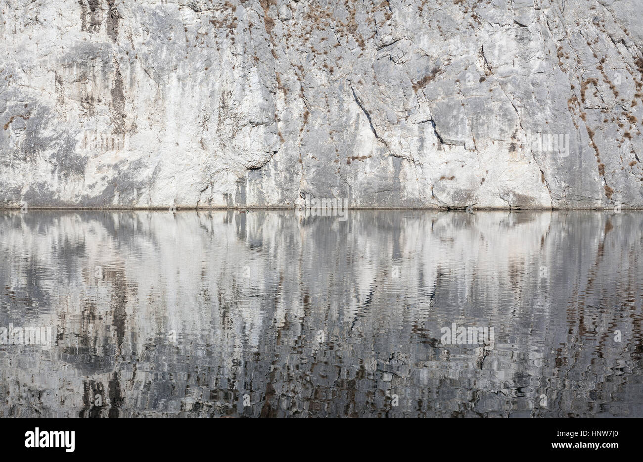 Abstract composition of water and mountain, reflections and stone. Stock Photo