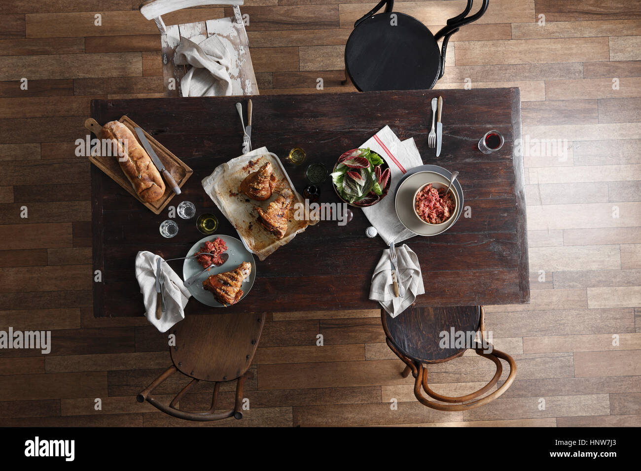 Pork hock, salad and fresh bread on restaurant table, overhead view Stock Photo