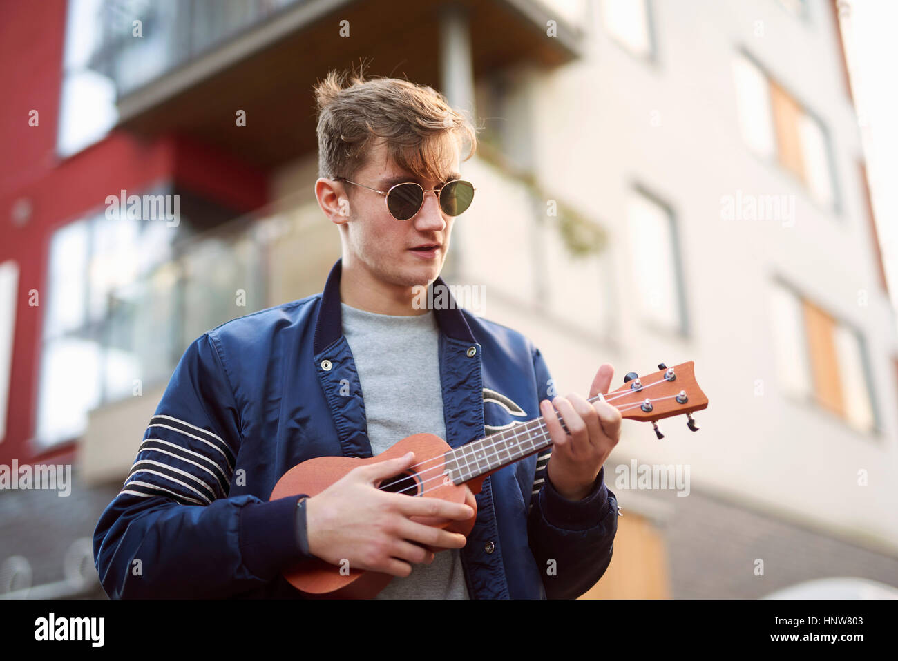 Young man on playing ukulele Stock Photo