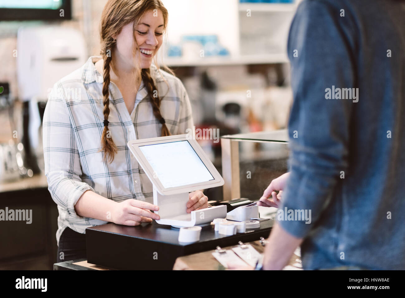 Cashier attending to customer in cafe Stock Photo