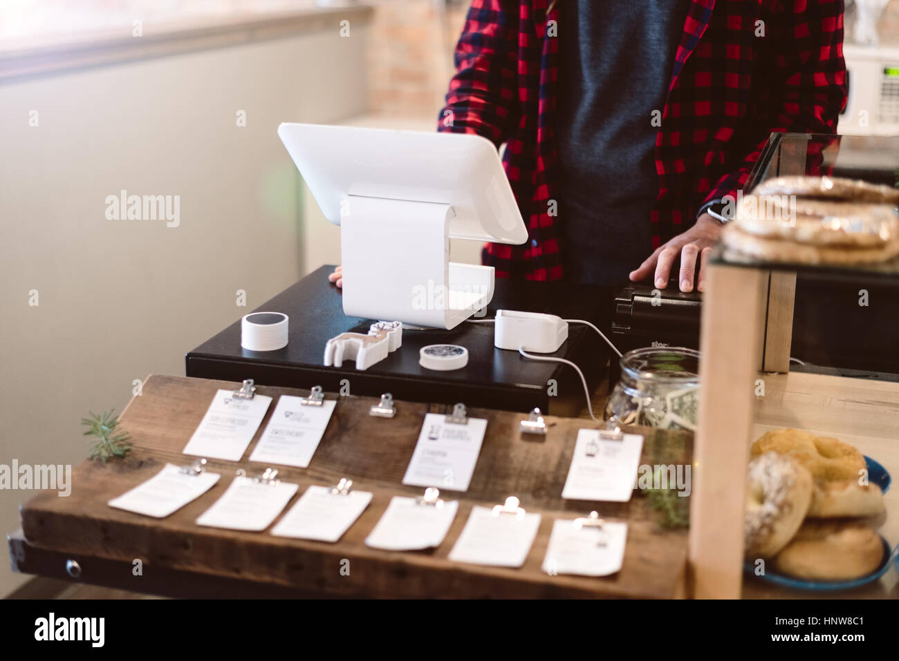 Cashier using cash register in cafe Stock Photo