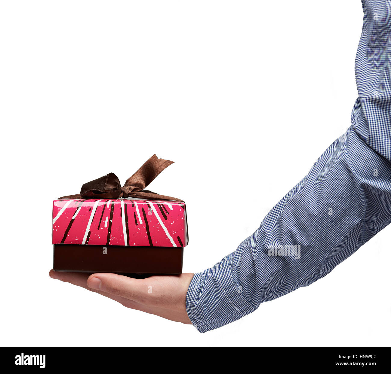 Gift small box on human palm wearing blue shirt isolated on white