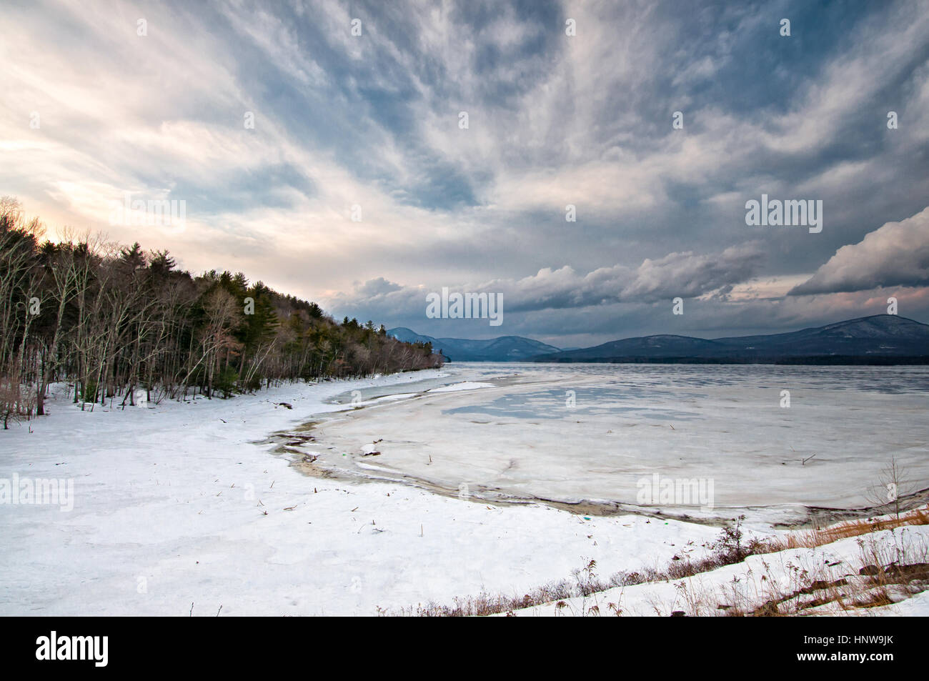 Ashokan Reservoir winter scene with dramatic sky, mountains, snow and